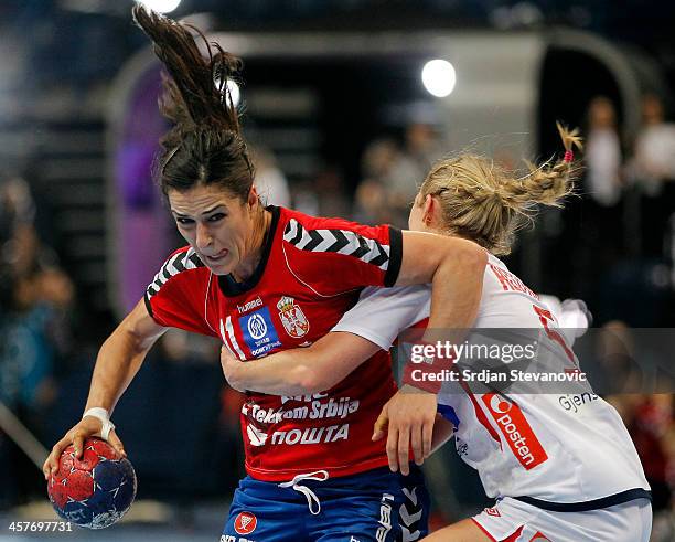 Sanja Damnjanovic of Serbia in action against Karoline Ida Alstad of Norway during the 2013 World Women's Handball Championship 2013 match between...