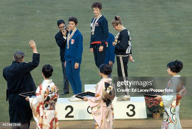 The medal presentation ceremony for the women's 800 metres event with, left to right, Maryvonne Dupureur of France , Ann Packer of Great Britain and...