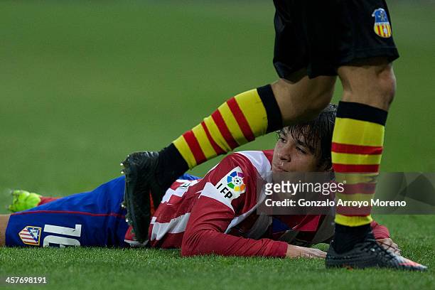 Oliver Torres of Atletico de Madrid looks on lied on the ground after being tackled during the Copa del Rey Round of 32 second leg match between Club...