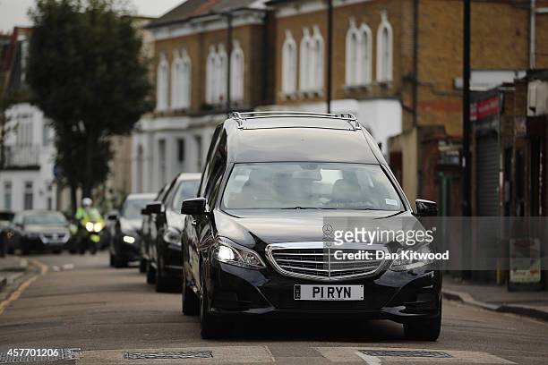 The funeral cortege for murdered teenager Alice Gross passes through Hanwell town centre on October 23, 2014 in London, England. The teenager Alice...