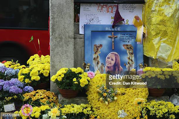 Flowers and messages of condolance besides the clock tower in Hanwell ahead of the funeral for murdered teenager Alice Gross on October 23, 2014 in...