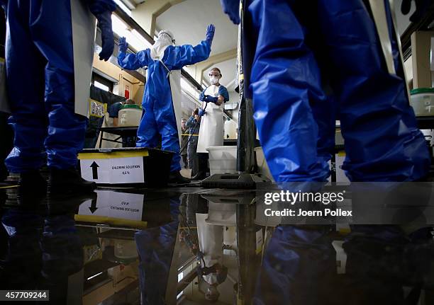 Volunteers who responded to a nationwide appeal by the German Red Cross to help in the fight against Ebola in Africa get decontaminated during...