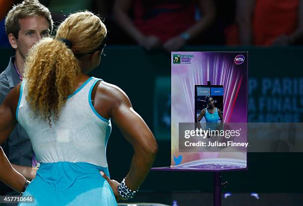 Serena Williams of USA tweets a picture of herself after her match against Eugenie Bouchard of Canada during day four of the BNP Paribas WTA Finals...