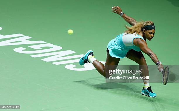 Serena Williams of the United States stretches to play a backhand against Eugenie Bouchard of Canada in their round robin matchduring the BNP Paribas...
