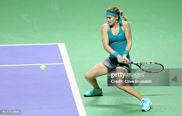 Eugenie Bouchard of Canada plays a backhand against Serena Williams of the United States in their round robin match during the BNP Paribas WTA Finals...