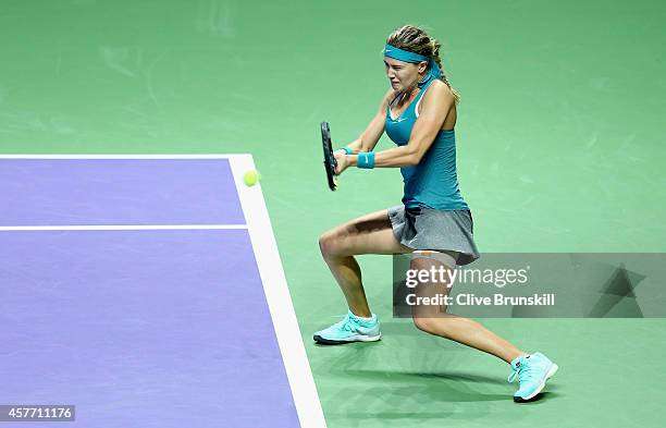 Eugenie Bouchard of Canada plays a backhand against Serena Williams of the United States in their round robin match during the BNP Paribas WTA Finals...