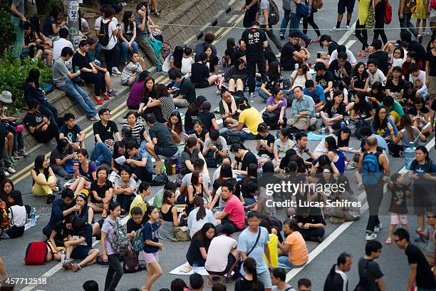 Protesters sit on Connaught road in pro-democracy 'Occupy Central' camp in Admirality, Hong Kong, on October 5, 2014. The 'Umbrella revolution' or...