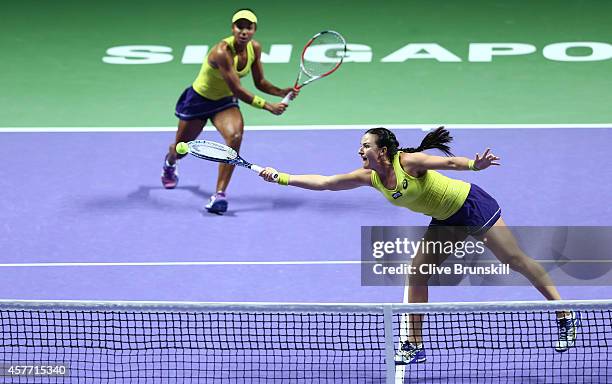 Abigail Spears and Raquel Kops-Jones of the United States in action against Cara Black of Zimbabwe and Sania Mirza of India in their doubles quarter...