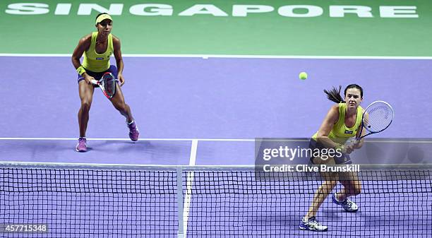 Abigail Spears and Raquel Kops-Jones of the United States in action against Cara Black of Zimbabwe and Sania Mirza of India in their doubles quarter...