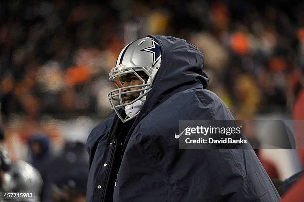 Jermey Parnell of the Dallas Cowboys ties to stay warm during a game against the Chicago Bears on December 9, 2013 at Soldier Field in Chicago,...