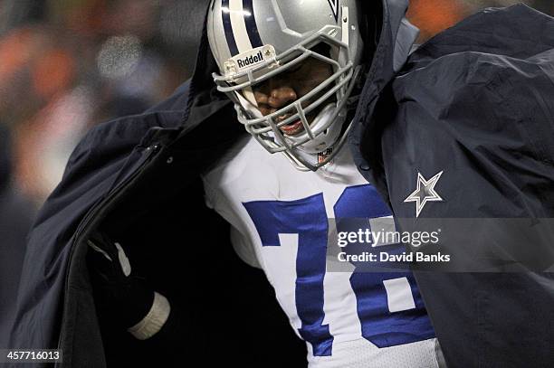 Jermey Parnell of the Dallas Cowboys ties to stay warm during a game against the Chicago Bears on December 9, 2013 at Soldier Field in Chicago,...