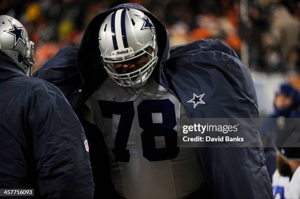 Jermey Parnell of the Dallas Cowboys ties to stay warm during a game against the Chicago Bears on December 9, 2013 at Soldier Field in Chicago,...