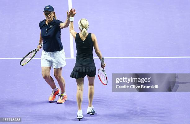 Martina Navratilova and Tracy Austin of the United States celebrate a point against Marion Bartoli of France and Iva Majoli of Croatia in the WTA...