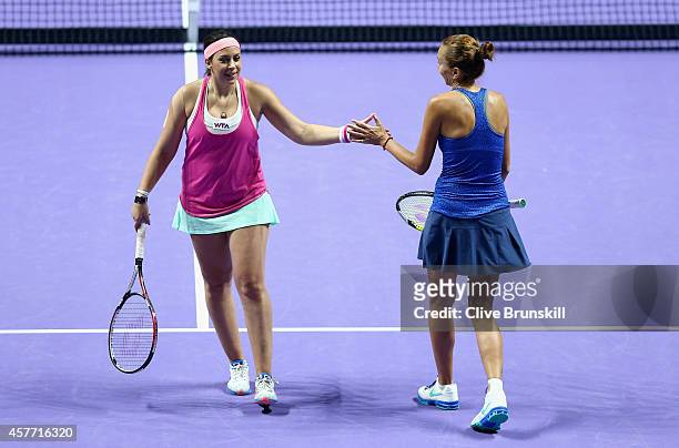 Marion Bartoli of France and Iva Majoli of Croatia celebrate a point against Martina Navratilova and Tracy Austin of the United States in the WTA...