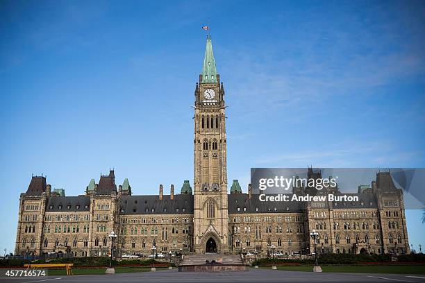 The flag atop the Main Parliament Building is flown at half staff one day after Cpl. Nathan Cirillo of the Canadian Army Reserves was killed while...