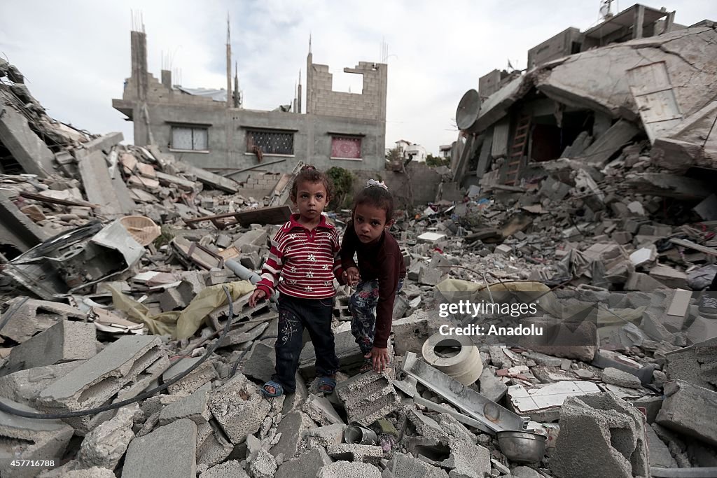 Palestinians search the debris of their houses for their belongings