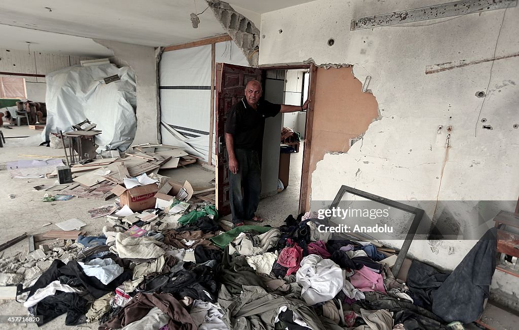 Palestinians search the debris of their houses for their belongings