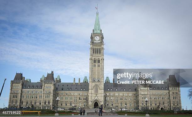 The Canadian Parliament is seen on October 23 in Ottawa, the day after multiple shootings in the capital city and Parliament buildings left a soldier...