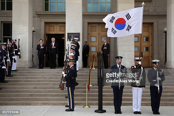 Secretary of Defense Chuck Hagel and National Defense Minister of Korea Han Min Koo listen to national anthems during a honor cordon at the Pentagon...
