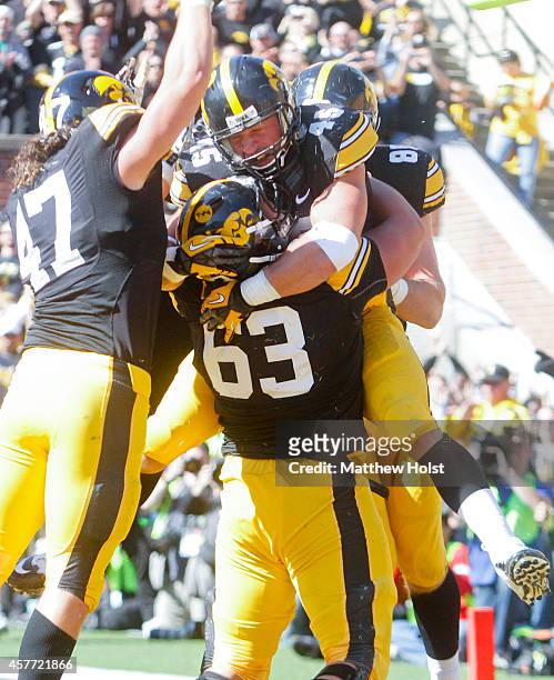 Running back Mark Weisman celebrates with offensive lineman Austin Blythe of the Iowa Hawkeyes after scoring a touchdown in the second quarter...