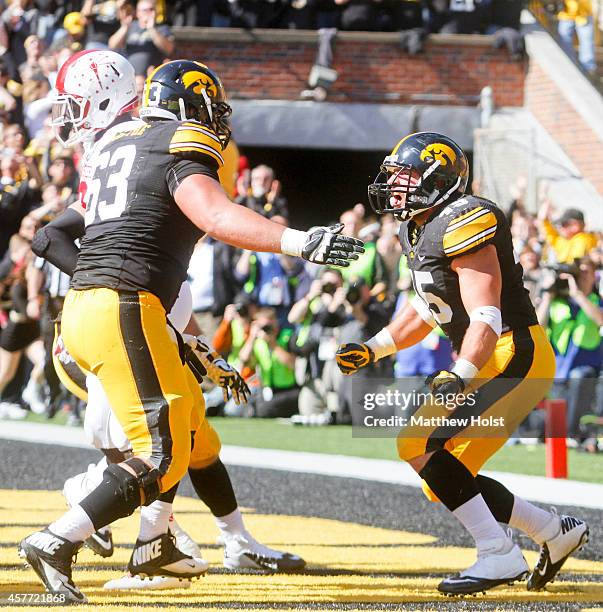 Running back Mark Weisman celebrates with offensive lineman Austin Blythe of the Iowa Hawkeyes after scoring a touchdown in the second quarter...