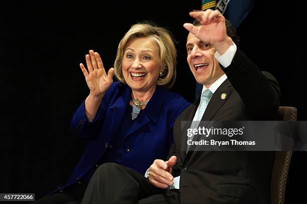 Former U.S. Secretary of State and U.S. Sen. Hillary Rodham Clinton and incumbent New York Governor Andrew Cuomo wave to the crowd during a "Women...