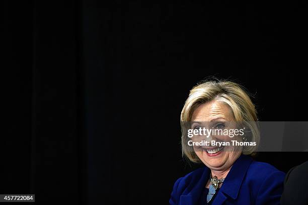 Former U.S. Secretary of State and U.S. Sen. Hillary Rodham Clinton smiles while Incumbent New York Governor Andrew Cuomo speaks during a "Women for...