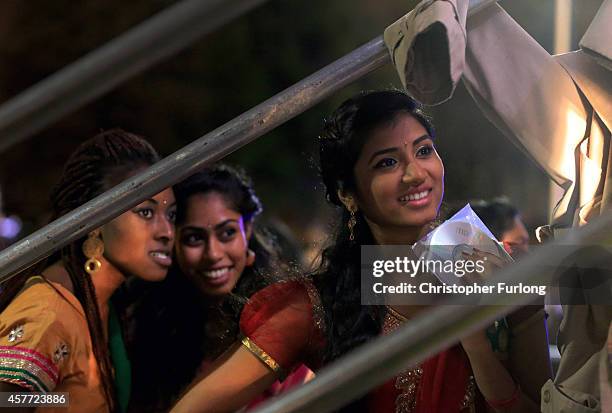 Dancers look on from backstage as they wait their turn to entertain people celebrating the Hindu festival of Diwali on October 23, 2014 in Leicester,...