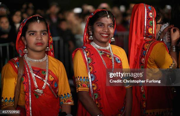 Young dancers look on from backstage as they wait their turn to entertain people celebrating the Hindu festival of Diwali on October 23, 2014 in...