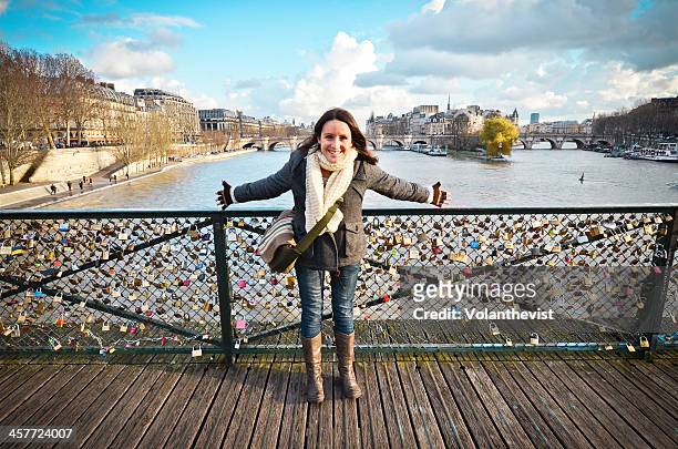 happy woman with open arms at pont des arts, paris - pont des arts padlocks stock pictures, royalty-free photos & images