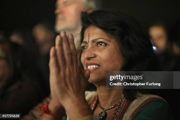 Woman in the audience watches dancers entertain the crowds during the Hindu festival of Diwali on October 23, 2014 in Leicester, England. Up to...