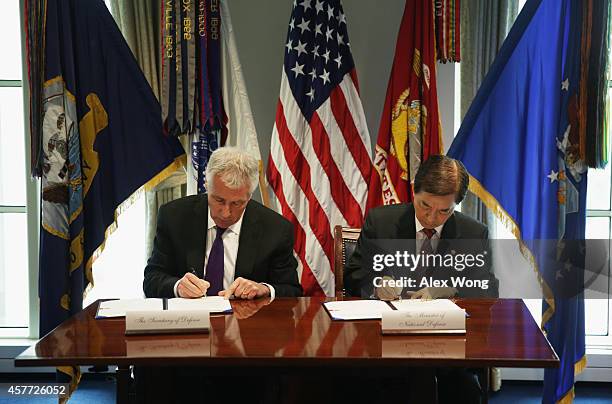 Secretary of Defense Chuck Hagel and National Defense Minister of Korea Han Min Koo sign a memorandum of understanding for the transfer of...