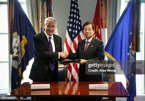 Secretary of Defense Chuck Hagel and National Defense Minister of Korea Han Min Koo shake hands after they signed a memorandum of understanding for...