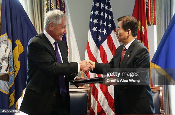 Secretary of Defense Chuck Hagel and National Defense Minister of Korea Han Min Koo shake hands after they signed a memorandum of understanding for...