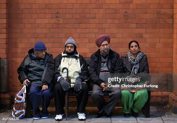 Locals take a rest on a bench as they celebrate the Hindu festival of Diwali on October 23, 2014 in Leicester, England. Up to 35,000 people attended...