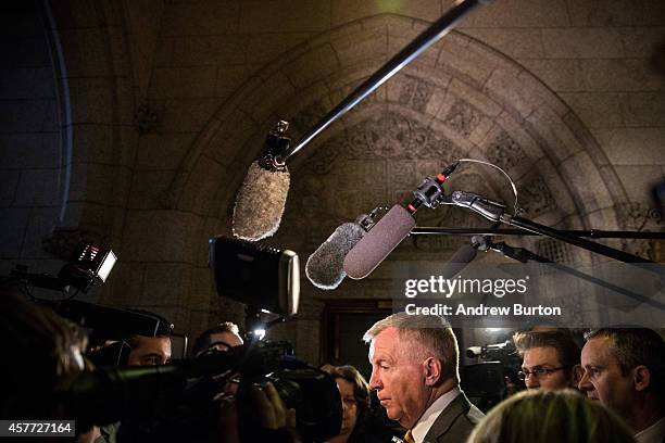 Laurie Hawn , a member of the Canadian parliament, speaks to the media outside the House of Commons in the Canadian Parliament one day after a gunman...