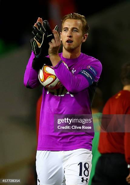 Harry Kane of Spurs, wearing the goalkeeper's shirt of team-mate Hugo Lloris, applauds the fans as holds the match ball following his hat-trick...