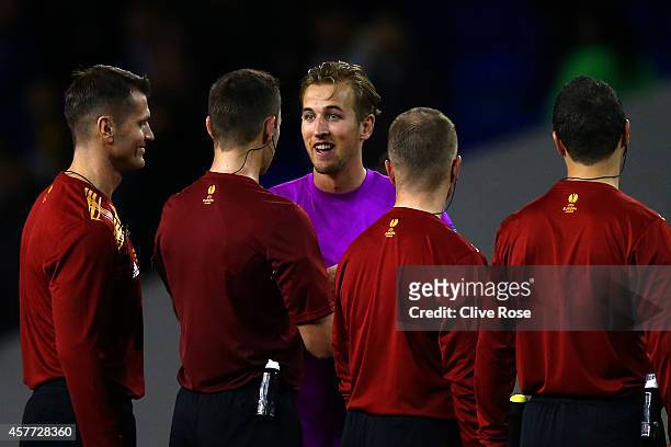 Harry Kane of Spurs, wearing the goalkeeper's shirt of team-mate Hugo Lloris, smiles as he speaks with the match officials during the UEFA Europa...