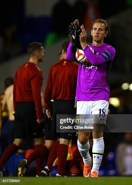 Harry Kane of Spurs, wearing the goalkeeper's shirt of team-mate Hugo Lloris, applauds the fans as holds the match ball following his hat-trick...