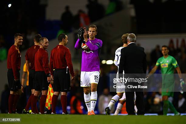 Harry Kane of Spurs, wearing the goalkeeper's shirt of team-mate Hugo Lloris, applauds the fans as holds the match ball following his hat-trick...