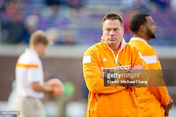 Head coach Butch Jones of the Tennessee Volunteers watches his team warm up prior to their game against the Mississippi Rebels on October 18, 2014 at...