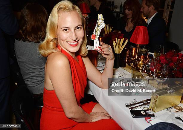 Charlotte Olympia Dellal poses with art by Clym Evernden at the Charlotte Olympia 'Handbags for the Leading Lady' launch dinner at Toto's Restaurant...