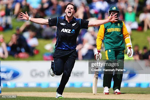 Mitchell McClenaghan of New Zealand celebrates the wicket of Quinton de Kock of South Africa during the One Day International match between New...