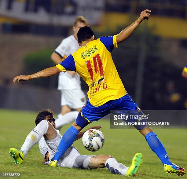 Argentina's Boca Juniors player Juan Forlin and Paraguayan Capiata's Gustavo Velazquez, vie during the Sudamericana Cup football match at the...