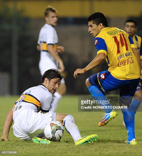 Argentina's Boca Juniors player Juan Forlin and Paraguayan Capiata's Gustavo Velazquez, vie during the Sudamericana Cup football match at the...