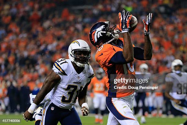 Wide receiver Emmanuel Sanders of the Denver Broncos makes a catch for a 31 yard second quarter touchdown ahead of cornerback Richard Marshall of the...