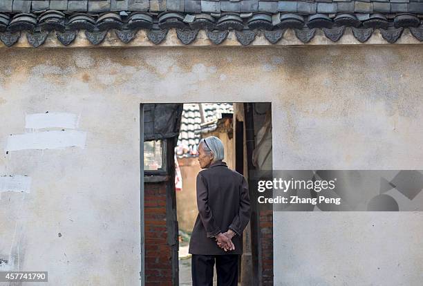 An old woman walks back to her old house in ancient Gaochun street. In China, there are more than 200 million old people of over 60 years old at...