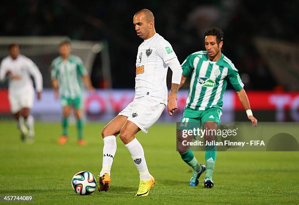Diego Tardelli of Atletico Mineiro passes the ball ahead of Adil Karrouchy of Raja Casablanca during the FIFA Club World Cup Semi Final match between...