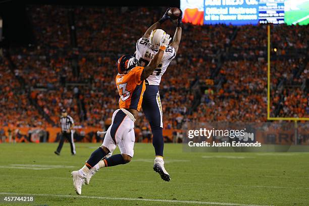 Tight end Antonio Gates of the San Diego Chargers leaps to make a fourth quarter 10-yard touchdown catch against strong safety T.J. Ward of the...