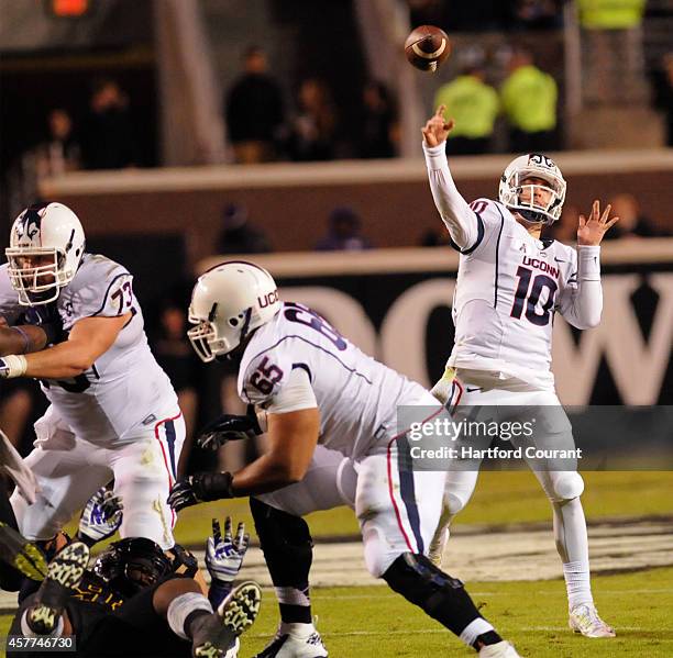 Connecticut quarterback Chandler Whitmer throws a pass in the third quarter against East Carolina at Dowdy-Ficklen Stadium in Greensville, N.C., on...